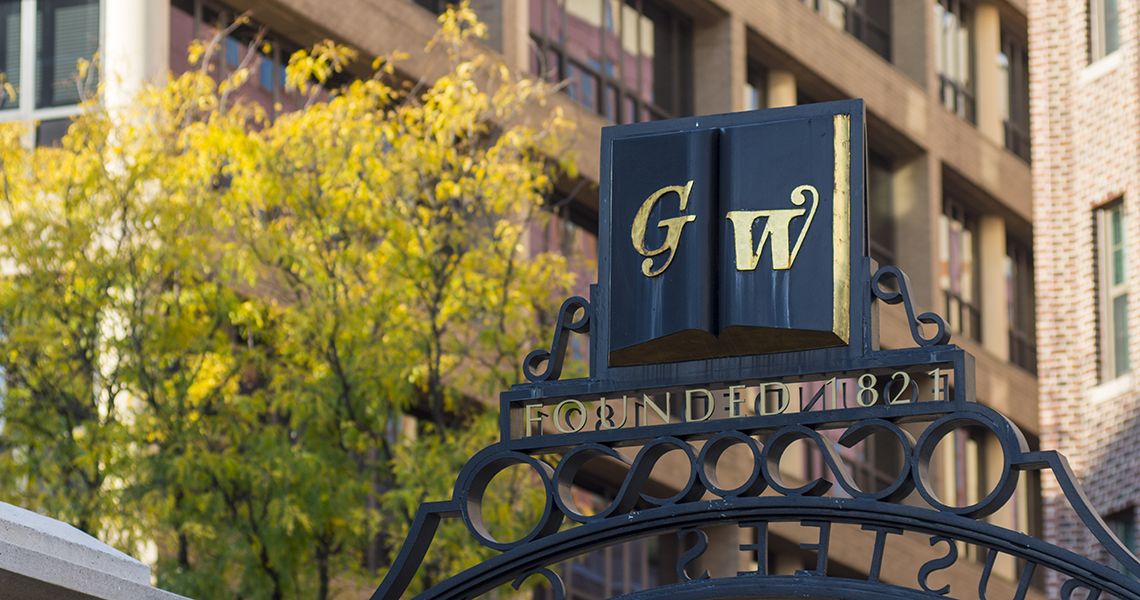 GW symbol on a campus gate overlooking campus