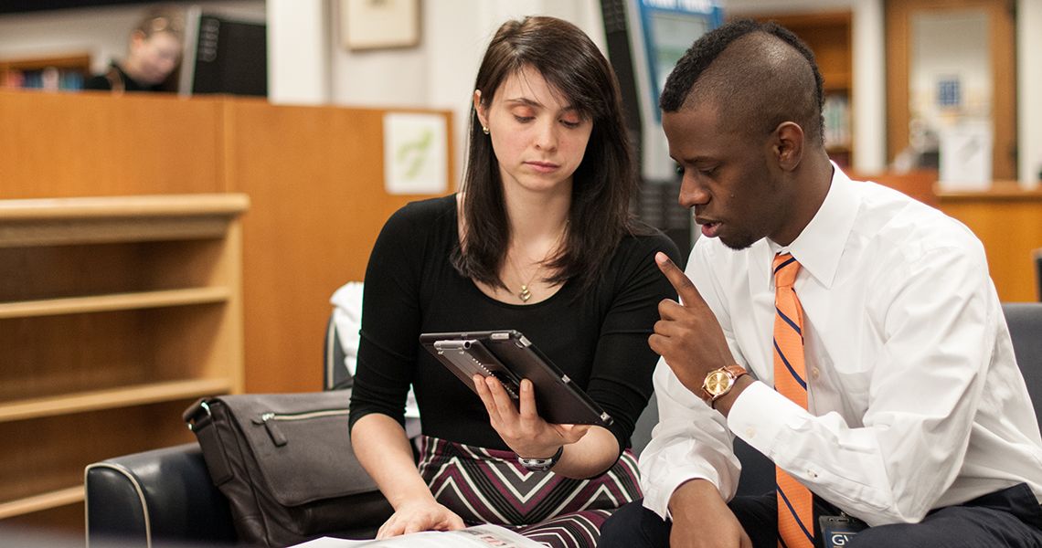 two people looking at a tablet together