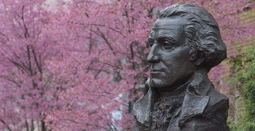 A bust of George Washington is shown on campus